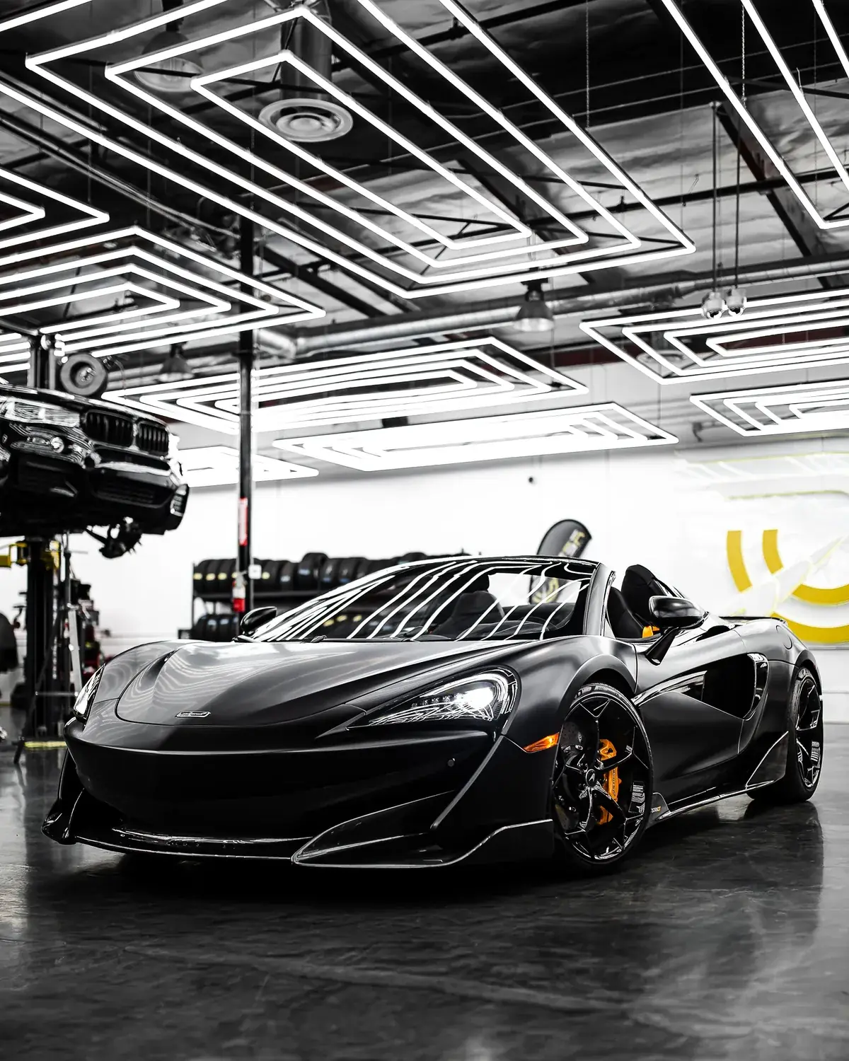 Black sports car in the workshop